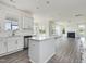 Spacious kitchen featuring a center island, stainless steel appliances, and an adjacent fireplace at 173 Copperleaf Court, Franklinton, NC 27525