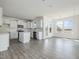 Bright open-concept kitchen featuring white cabinets, stainless appliances, and modern finishes at 173 Copperleaf Court, Franklinton, NC 27525