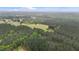Aerial view shows home surrounded by lush forestry at 1850 Willie Pace Rd, Burlington, NC 27217