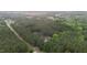 Aerial shot capturing a home surrounded by dense woods, along a tranquil country road at 1850 Willie Pace Rd, Burlington, NC 27217