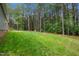 View of a spacious backyard featuring a lush green lawn and mature trees at 1850 Willie Pace Rd, Burlington, NC 27217