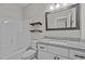 Bright bathroom showcasing a tub, sink, floating shelves and framed mirror at 1850 Willie Pace Rd, Burlington, NC 27217