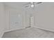 Carpeted bedroom with a ceiling fan, closet and view to the attached bathroom at 1850 Willie Pace Rd, Burlington, NC 27217