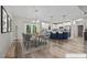 Staged dining area with modern table, chairs, and view into the kitchen, creating an inviting atmosphere at 1850 Willie Pace Rd, Burlington, NC 27217