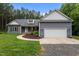 Charming one story home featuring a two-car garage, landscaped front yard, and inviting curb appeal at 1850 Willie Pace Rd, Burlington, NC 27217