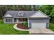 Charming one story home featuring a two-car garage, landscaped front yard, and inviting curb appeal at 1850 Willie Pace Rd, Burlington, NC 27217