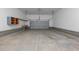 An empty garage space featuring concrete floors, gray foundation, and closed garage door at 1850 Willie Pace Rd, Burlington, NC 27217