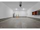 Spacious garage featuring concrete flooring, white walls, overhead lighting, and ample storage space at 1850 Willie Pace Rd, Burlington, NC 27217