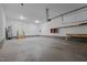 Bright, spacious garage offering concrete flooring, storage shelves, and a door with steps leading outside at 1850 Willie Pace Rd, Burlington, NC 27217