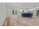 A kitchen with a navy blue island, stainless steel appliances and an open concept living space at 1850 Willie Pace Rd, Burlington, NC 27217