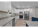 Modern kitchen featuring white cabinets, granite countertops, stainless steel appliances and an eat-in island at 1850 Willie Pace Rd, Burlington, NC 27217