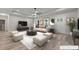 Bright, staged living room with modern furniture, a ceiling fan, and plenty of space for entertaining at 1850 Willie Pace Rd, Burlington, NC 27217