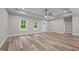 Bright, open living room with modern flooring, a ceiling fan, and neutral paint, offering versatility at 1850 Willie Pace Rd, Burlington, NC 27217