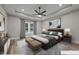 Virtually staged bedroom featuring neutral walls, wood flooring, a ceiling fan and large picture window at 1850 Willie Pace Rd, Burlington, NC 27217