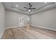 A view of the main bedroom with light colored walls, wood flooring, and a modern ceiling fan at 1850 Willie Pace Rd, Burlington, NC 27217