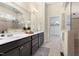 Bathroom featuring double sink vanity, tiled shower and large mirror at 204 Mill Chapel Rd, Chapel Hill, NC 27517