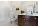 Bathroom featuring a shower-tub combination with white subway tile and a dark wood vanity at 204 Mill Chapel Rd, Chapel Hill, NC 27517