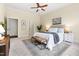 Bright bedroom featuring neutral walls, carpet, and view to hall and stairway at 204 Mill Chapel Rd, Chapel Hill, NC 27517