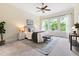 Bright bedroom featuring neutral walls, carpet, ceiling fan, and backyard view through large windows at 204 Mill Chapel Rd, Chapel Hill, NC 27517