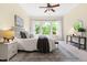 Bright bedroom featuring neutral walls, carpet, ceiling fan, and backyard view through large windows at 204 Mill Chapel Rd, Chapel Hill, NC 27517