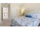 Cozy bedroom with a decorative headboard, a nightstand with a lamp, and neutral wall paint at 204 Mill Chapel Rd, Chapel Hill, NC 27517