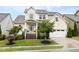 Charming two-story home featuring a manicured lawn, inviting entryway, and attached two-car garage at 204 Mill Chapel Rd, Chapel Hill, NC 27517