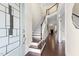 Bright foyer showcasing hardwood floors, a staircase, and a view into the living room at 204 Mill Chapel Rd, Chapel Hill, NC 27517