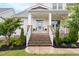 Close-up of home's entryway with brick stairs, white railings, and a front door with glass panes at 204 Mill Chapel Rd, Chapel Hill, NC 27517