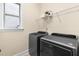 Laundry room boasting side-by-side stainless washer and dryer with overhead storage at 204 Mill Chapel Rd, Chapel Hill, NC 27517