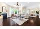 Bright living room features hardwood floors, neutral walls, fireplace, modern furnishings, and large windows with backyard views at 204 Mill Chapel Rd, Chapel Hill, NC 27517