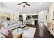 Open living room features hardwood floors, neutral walls, fireplace, modern furnishings, and large windows with backyard views at 204 Mill Chapel Rd, Chapel Hill, NC 27517