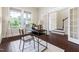 Home office with large windows, natural light, hardwood floors and a modern desk and chair at 204 Mill Chapel Rd, Chapel Hill, NC 27517