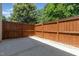 Private backyard featuring a stained wood fence, concrete surface, and views of mature trees at 2111 Piney Brook Rd # 101, Raleigh, NC 27614