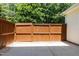 Fenced backyard featuring a stained wood fence, concrete surface, and views of mature trees at 2111 Piney Brook Rd # 101, Raleigh, NC 27614