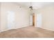 Spacious bedroom featuring neutral carpet, ceiling fan, and multiple doors at 2111 Piney Brook Rd # 101, Raleigh, NC 27614