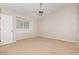 Bedroom with neutral carpet, ceiling fan, and a large window with natural light at 2111 Piney Brook Rd # 101, Raleigh, NC 27614