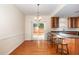 Bright dining room with wood floors, chandelier, and access to the outdoor space at 2111 Piney Brook Rd # 101, Raleigh, NC 27614