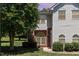 Charming two-story home featuring beautiful windows, manicured lawn, and verdant landscaping at 2111 Piney Brook Rd # 101, Raleigh, NC 27614