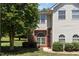Charming two-story home featuring beautiful windows, manicured lawn, and verdant landscaping at 2111 Piney Brook Rd # 101, Raleigh, NC 27614