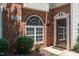 Inviting brick entrance with decorative window and well-maintained landscaping at 2111 Piney Brook Rd # 101, Raleigh, NC 27614