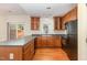 Kitchen features wood cabinets, modern appliances, and a countertop with space for seating at 2111 Piney Brook Rd # 101, Raleigh, NC 27614