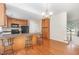 Well-lit kitchen with wood floors, appliances and a breakfast bar at 2111 Piney Brook Rd # 101, Raleigh, NC 27614