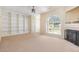 Large living room with neutral carpet, fireplace, built-in shelving, and lots of light at 2111 Piney Brook Rd # 101, Raleigh, NC 27614
