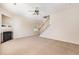 Spacious living room with neutral carpet, fireplace, and staircase at 2111 Piney Brook Rd # 101, Raleigh, NC 27614