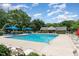 Community swimming pool with lounge chairs and trees around the pool at 2111 Piney Brook Rd # 101, Raleigh, NC 27614