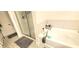 This bathroom features a tub and glass-enclosed shower with neutral tile surround at 212 Placid Pond Dr, Broadway, NC 27505
