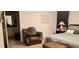 Cozy bedroom featuring a sitting chair, decor, and a large king-size bed, perfect for relaxation and rest at 212 Placid Pond Dr, Broadway, NC 27505