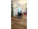Dining room featuring laminate floor, modern light fixture and seating for four at 212 Placid Pond Dr, Broadway, NC 27505