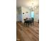 Dining room featuring laminate floor, modern light fixture and seating for four at 212 Placid Pond Dr, Broadway, NC 27505