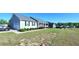 Inviting home featuring a covered porch, attached garage, and a beautifully landscaped front yard at 212 Placid Pond Dr, Broadway, NC 27505